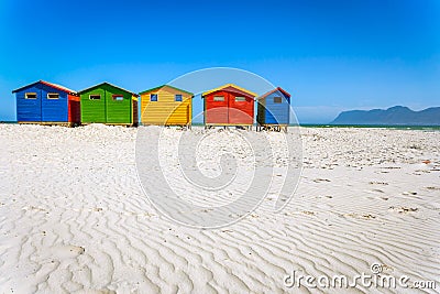 Muizenberg beach with white sand and colorful wooden cabins in Cape Town Stock Photo