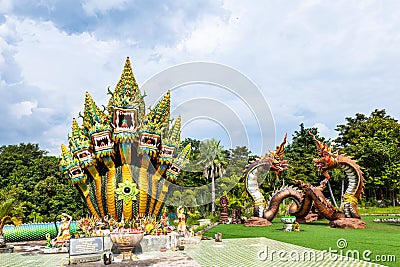 Mukdahan, Thailand - July 31, 2022: 7 Heads of great serpent statues named Srisattanakarat with Two Naga Lovers at Wat Dan Phra In Editorial Stock Photo