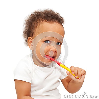 Mulatto black baby brushing teeth. Stock Photo