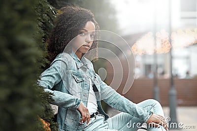 Mulatto black curly girl on street Stock Photo