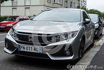 Front view of grey Honda civic parked in the street by rainy day Editorial Stock Photo