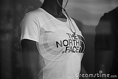 White teeshirt by the north face brand on mannequin in a fashion store showroom Editorial Stock Photo