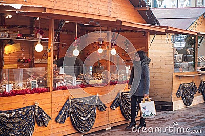 Woman in front of pastry stand at the christmas market Editorial Stock Photo