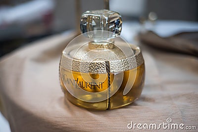 Big bottle of perfume by Yves Saint Laurent at the flea market Editorial Stock Photo