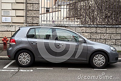 Profile view of grey Volkswagen Golf 6 parked in the street Editorial Stock Photo