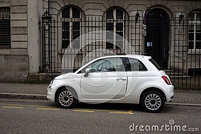 Profile view of white Fiat 500 parked in the street Editorial Stock Photo