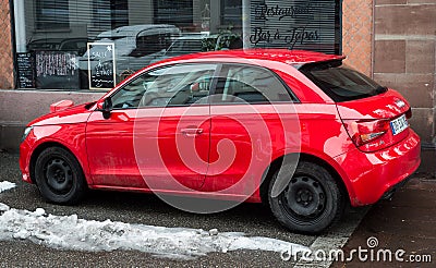 Profile view of red Audi A1 parked in the street, Audi is the famous german brand of cars Editorial Stock Photo