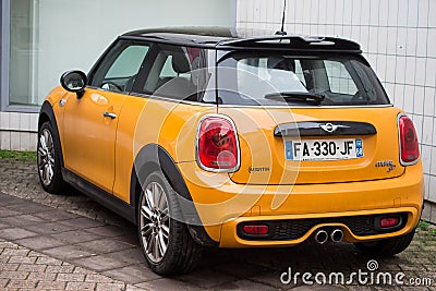 Rear view of orange color mini cooper SD parked in the street, mini is the famous british brand of small cars Editorial Stock Photo