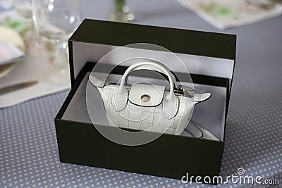 white mini handbag by Longchamp in a luxury carton box on a table Editorial Stock Photo