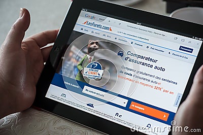 Closeup of woman hands on the insurance comparator - les furets.com, the home page of web site on tablet Editorial Stock Photo