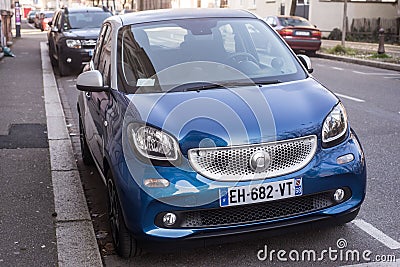 Front view of blue smart car parked in the street Editorial Stock Photo
