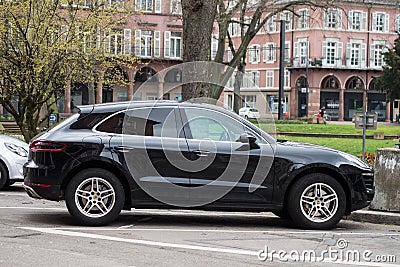 Profile view of black Porsche Macan SUV car parked in the street Editorial Stock Photo