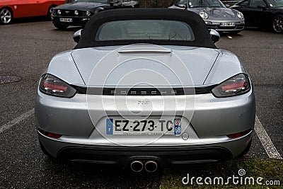 Rear view of grey Porsche 718 parked in the street by rainy day Editorial Stock Photo