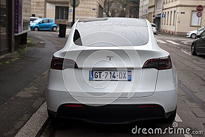 rear view of white testa electric car parked in the street Editorial Stock Photo