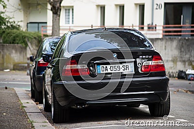 Rear view of black BMW 330d parked in the street Editorial Stock Photo