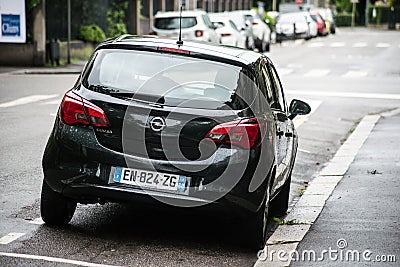 Rear view of black Opel Corsa parked in the street by rainy day Editorial Stock Photo