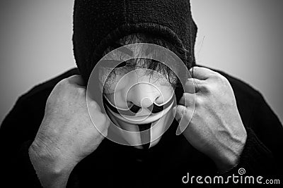 Womman wearing Vendetta mask. This mask is a well-known symbol for the online hacktivist group Anonymous Editorial Stock Photo