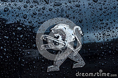 Rain drops on peugeot lion logo on black car front parked in the street Editorial Stock Photo