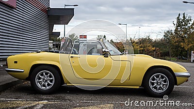 Profile view of Yellow vintage Lotus Elan roadster parked in the street Editorial Stock Photo