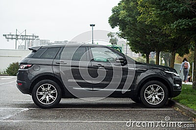 black land rover 4X4 parked in the street by rainy day Editorial Stock Photo