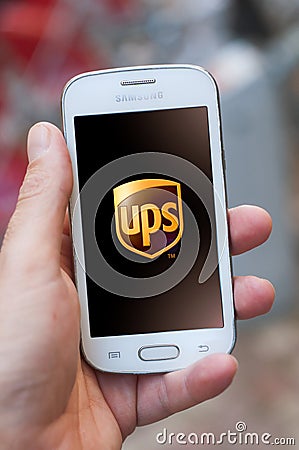 Closeup of UPS logo on smartphone screen in hand from Samsung brand in the street Editorial Stock Photo