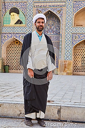 Mullah in a turban stands in Jame Mosque, Isfahan, Iran. Editorial Stock Photo