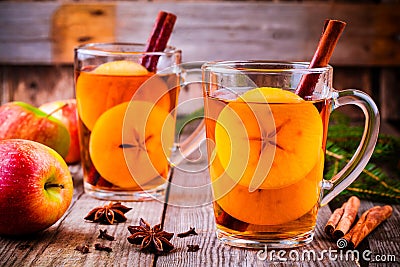 Mulled apple cider with cinnamon and anis in glass mugs Stock Photo