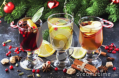 Mulled wine and mulled cider. Hot winter drinks and cocktails for christmas or new year`s eve in glass mugs with spices and citru Stock Photo