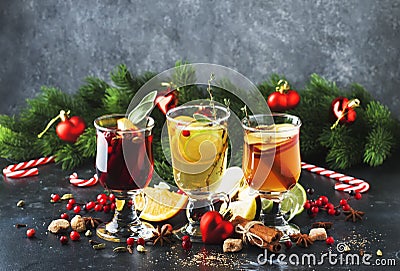 Mulled wine and mulled cider. Hot winter drinks and cocktails for christmas or new year`s eve in glass mugs with spices and citru Stock Photo