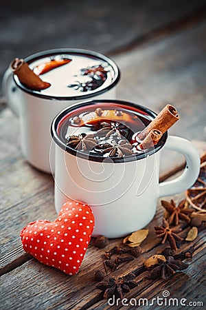 Mulled wine in rustic mugs with spices and red heart Stock Photo