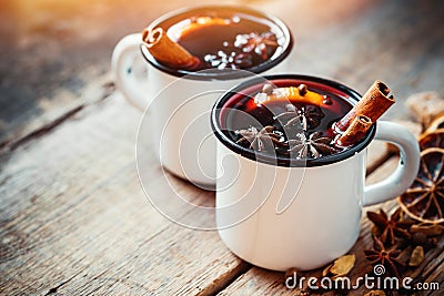 Mulled wine in white rustic mugs with spices Stock Photo