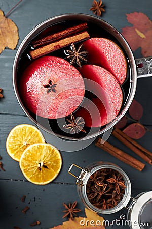 Mulled wine. Winter hot drink with citrus, apple and spices. Stock Photo