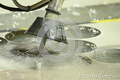 The multi-axis abrasive waterjet cutting machine cutting the metal plate Stock Photo