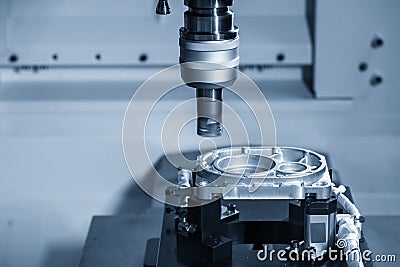 The multi-axis CNC milling machine face cutting at the aluminium casting automotive parts by indexable flat tools . Stock Photo