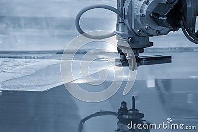 The multi-axis waterjet cutting machine cutting the aluminum plate Stock Photo