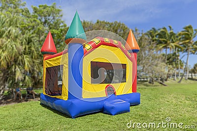 A multi-color castle bounce house photographed from the left side Stock Photo