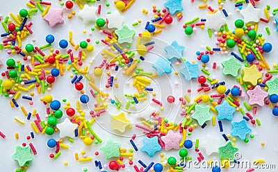 Multi-color festive background of a scattering of sugar candy sprinkles for cupcakes and other pastries in form of stars, sticks Editorial Stock Photo