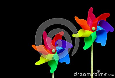 Pair of multi color pinwheels on black background Stock Photo