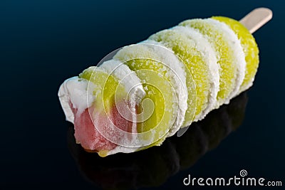 Multi color popsicle with bites on black background Stock Photo