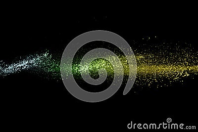 Multi color powder explosion on black background.Blue yellow and green dust cloud in the air Stock Photo