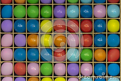 Multi-colored balls on a wooden bench. Game of throwing darts into balls, fun in the park. The concept of entertainment and fun. Stock Photo