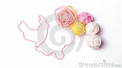 Multi-colored balls of wool yarn with a heart of thread Stock Photo