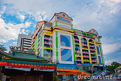 Multi-colored building and a Chinese temple. Kuching. Sarawak. Borneo.Malaysia. Editorial Stock Photo