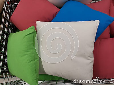 Multi colored decorative pillows in a basket Stock Photo
