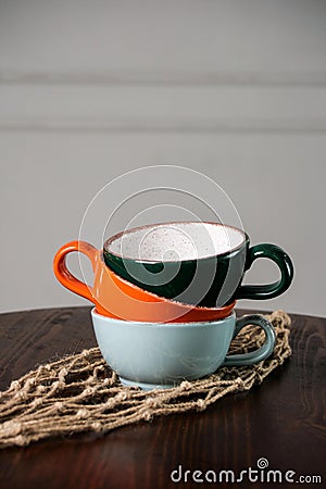 Multi-colored empty cups on the wooden table Stock Photo