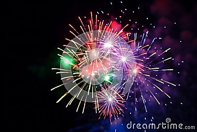 Multi colored fireworks salute new year 2024 magic night bright light effects show illuminated holiday celebrate Stock Photo