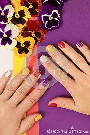 Multi-colored juicy manicure on short female nails Stock Photo