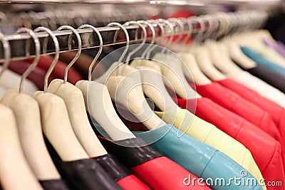 Multi-colored leather jackets hang on hanger in store Stock Photo