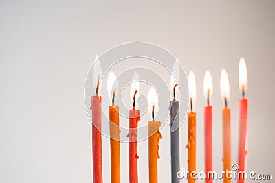 Multi-colored lighted candles on chanukiah closeup Stock Photo