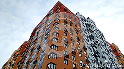 Multi-colored modern multi-storey residential building and multi-apartment panel house with Windows and balconies Stock Photo